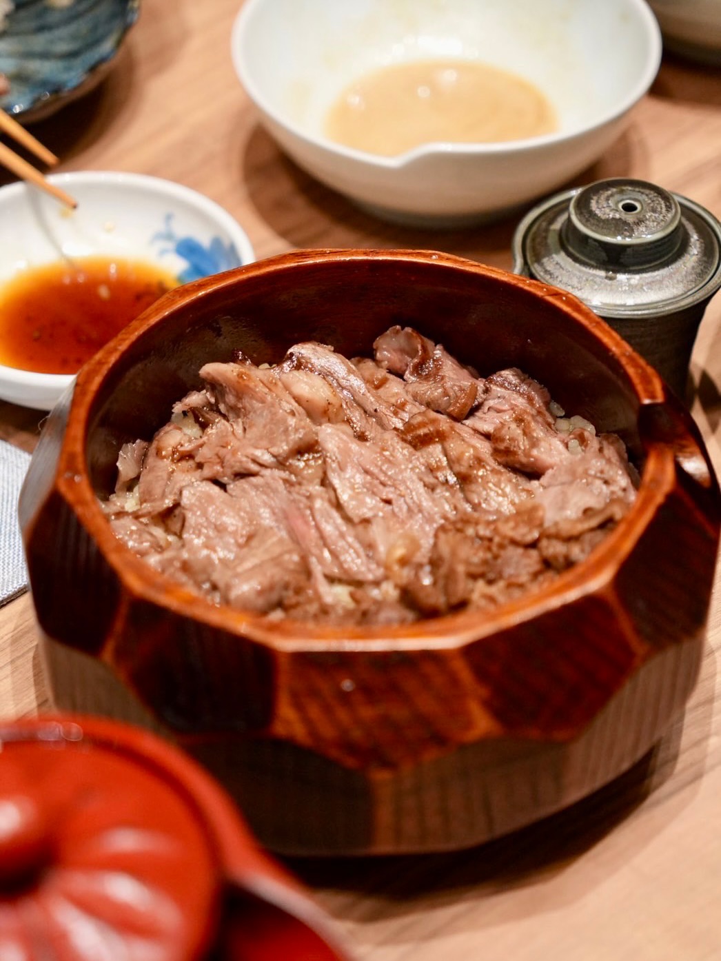 Akaushi Hitsumabushi — a rare treasure, simmered to perfection.

Inspired by the traditional Japanese “Hitsumabushi,” this dish is reimagined with exquisite Akaushi beef one of Japan’s rarest wagyu breeds. Served over rice with carefully crafted condiments, it invites you to enjoy in three delightful ways: savor as it is, mix with condiments, or pour over with savory dashi broth.
An experience that transforms with every bite.

#KOUBAI #KOUBAIBKK