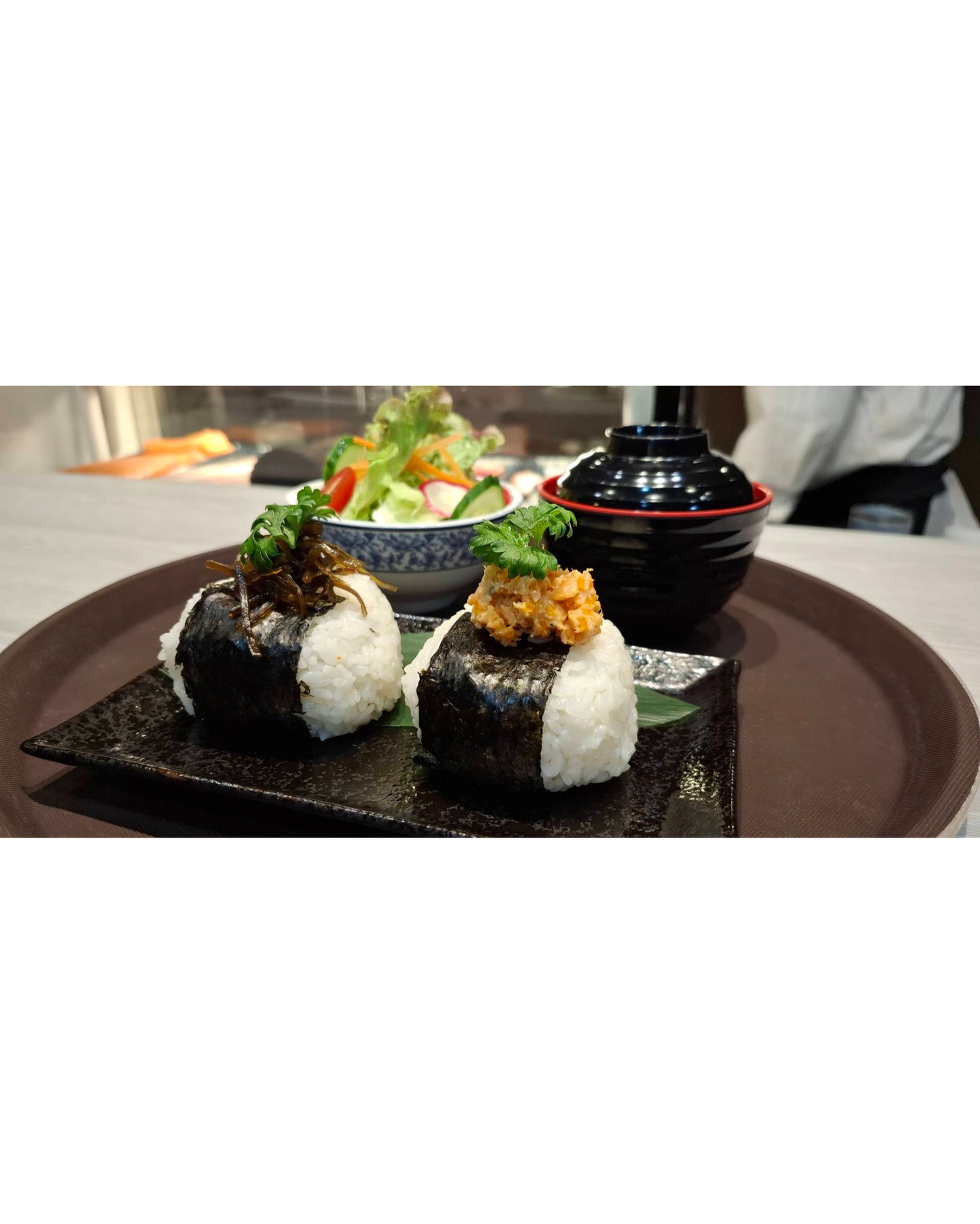 We're thrilled to introduce our new Onigiri Set! 🎊 Craft your perfect meal with the ability to select your favorite fillings. Each set is served with a steaming bowl of miso soup 🍲 and a fresh, crispy salad 🥗. Whether you're a long-time onigiri enthusiast or a curious newcomer, this customizable experience is one you can't miss. Choose from a variety of delicious fillings, from traditional salmon and umeboshi to modern twists like spicy tuna or avocado. Our chefs are eager to see which combinations you'll create! So swing by and treat yourself to this delightful Japanese comfort food experience that is perfect for any time of day. Light, filling, and oh-so-satisfying, our Onigiri Set is waiting for you to make it your own. We look forward to serving you and making your dining experience unforgettable! 🌸           🍣

เราตื่นเต้นที่จะแนะนำชุดโอนิกิริใหม่ของเรา! 🎊 รังสรรค์มื้ออาหารที่สมบูรณ์แบบของคุณด้วยความสามารถในการเลือกไส้ที่คุณชื่นชอบ แต่ละชุดเสิร์ฟพร้อมซุปมิโซะร้อนๆ 🍲 และสลัดสดใหม่กรอบ 🥗 ไม่ว่าคุณจะเป็นผู้ที่ชื่นชอบโอนิกิริมาอย่างยาวนานหรือมือใหม่ที่อยากรู้อยากเห็น ประสบการณ์ที่สามารถปรับแต่งได้นี้เป็นสิ่งที่คุณไม่ควรพลาด เลือกจากไส้แสนอร่อยหลากหลายชนิด ตั้งแต่แซลมอนและอุเมะโบชิแบบดั้งเดิม ไปจนถึงไส้แบบโมเดิร์นอย่างทูน่ารสเผ็ดหรืออะโวคาโด เชฟของเรากระตือรือร้นที่จะดูว่าคุณจะสร้างสรรค์ส่วนผสมแบบไหน! แวะมาและปรนเปรอตัวเองด้วยประสบการณ์อาหารญี่ปุ่นแสนอร่อยนี้ที่เหมาะสำหรับทุกช่วงเวลาของวัน ชุดโอนิกิริของเราเบา อิ่มท้อง และอิ่มอร่อย รอให้คุณรังสรรค์เป็นของคุณเอง เรารอคอยที่จะเสิร์ฟคุณและทำให้ประสบการณ์การรับประทานอาหารของคุณน่าจดจำ! 🌸 🍣

#OnigiriLovers
#กินซุย
#Japanese food
#อาหารญี่ปุ่น
#ย่านนานา