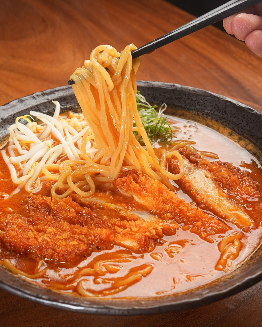 Pork Rib Red Miso Ramen – Bold, Rich, Satisfying.

Tender, flavorful pork ribs served with a deep red miso broth,
creating a powerful blend of umami and hearty richness.
A full-bodied bowl that warms you from the first sip to the last.

ราเม็งกระดูกหมูตุ๋น ซุปมิโซะแดง – เข้มข้น หนักแน่น อร่อยสะใจ

ซี่โครงหมูนิ่มละลาย เสิร์ฟคู่กับน้ำซุปมิโซะแดงรสลึก
อูมามิแน่นๆ หอมมัน และอิ่มสะใจ
เป็นชามที่ให้พลัง ทั้งรสชาติและความอิ่มแบบเต็มๆ

Real Ramen. Real Flavor.
Open 11:00–03:00
📞 095 587 9759