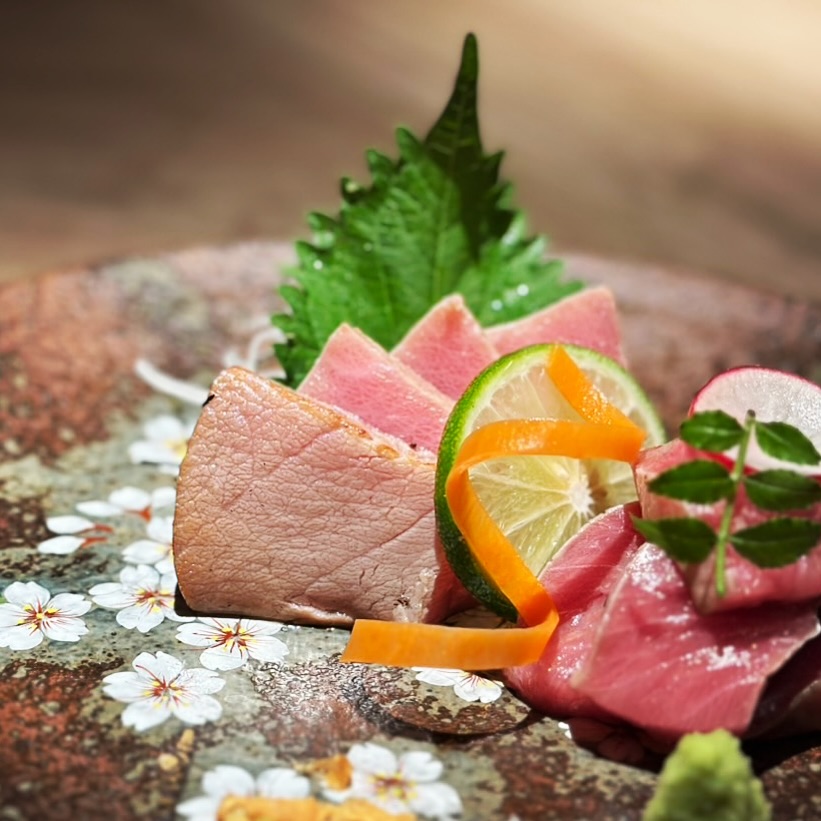 Straw-Grilled Fresh Bluefin Tuna

Fresh bluefin tuna is quickly seared over high-heat straw fire,
creating a smoky aroma while keeping the center rare.

The outside is lightly seared to enhance umami,
while the inside remains tender and silky.

Enjoy the rich flavor and natural sweetness of premium tuna.

⸻

มากุโระสดย่างฟาง 

ปลามากุโระสดคุณภาพสูง นำมาย่างด้วยไฟฟางที่ร้อนจัดอย่างรวดเร็ว
ทำให้ด้านนอกมีกลิ่นหอมควันเล็กน้อย แต่ด้านในยังคงความดิบแบบเรร์

สัมผัสด้านนอกจะหอมและแน่นขึ้น ส่วนด้านในนุ่มละมุน
ได้รสหวานและความมันของปลามากุโระอย่างชัดเจนครับ

#bangkokrestaurant 
#bangkokseafood 
#robata
#bangkokfoodies