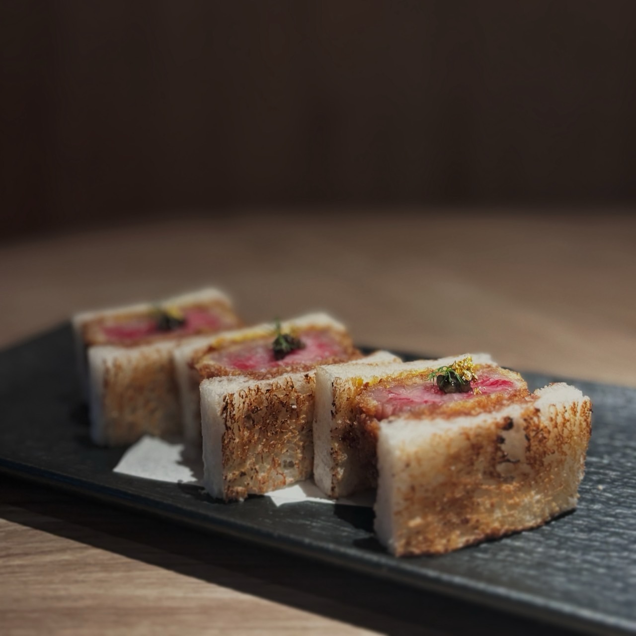 A5 Wagyu Sirloin Katsu Sando

A luxurious katsu sando made with A5 Wagyu sirloin, prized for its exceptional marbling and rich, buttery flavor. Served with our homemade red wine sauce and Tasmanian mustard for a refined balance of richness and acidity.

คัตสึซันโดที่ใช้เนื้อวากิว A5 ส่วนเซอร์ลอยน์ โดดเด่นด้วยลายไขมันที่ละเอียด เนื้อนุ่ม และรสชาติหวานมันอย่างเป็นธรรมชาติ เสิร์ฟคู่กับซอสไวน์แดงโฮมเมดรสเข้มข้นและมัสตาร์ดแทสเมเนียที่ช่วยเพิ่มความสดชื่นและตัดความมันได้อย่างลงตัว

#bangkokfoodies 
#bangkokrestaurants 
#bangkokjapaneserestaurant 
#bangkokseafood
